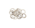 A pile of silver metal locking washers with teeth around the inner edge on a white background.