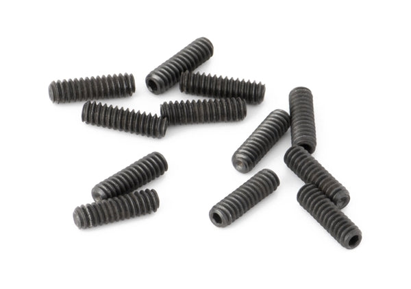 Twelve small black threaded screws arranged loosely on a white background.