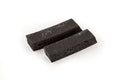 Two black rectangular foam strips on a white background.