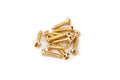 A group of small golden metal screws with cross-shaped heads arranged on a white surface.