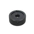Black knurled round control knob with a central hole and a set screw on the side.