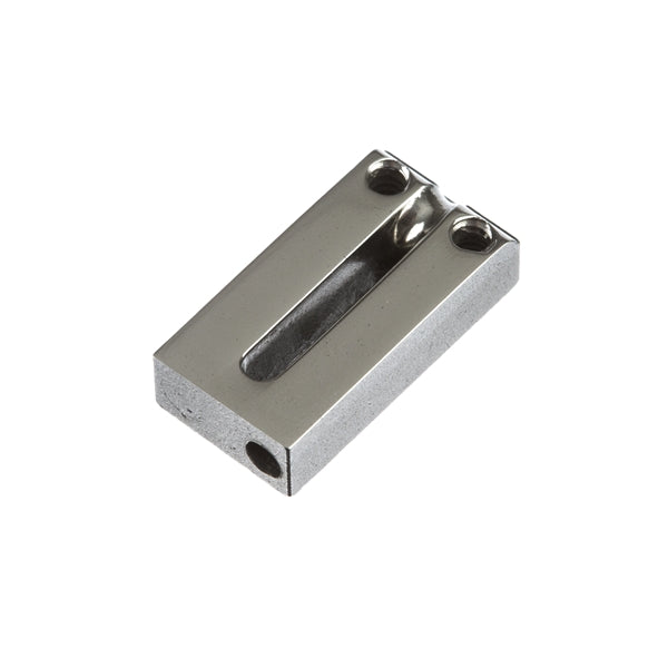 Close-up of a small rectangular metal component with two screw holes and a groove in the center.