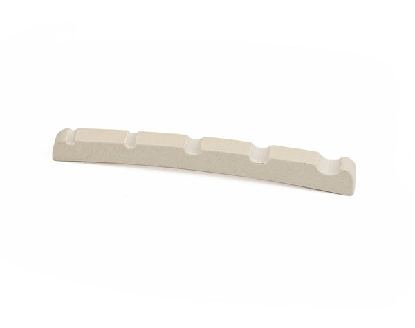 Off-white pre-slotted guitar string nut with five string slots on white background.