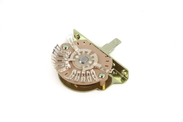 Tan disc-style rotary switch with five solder terminals and a metal mounting bracket.