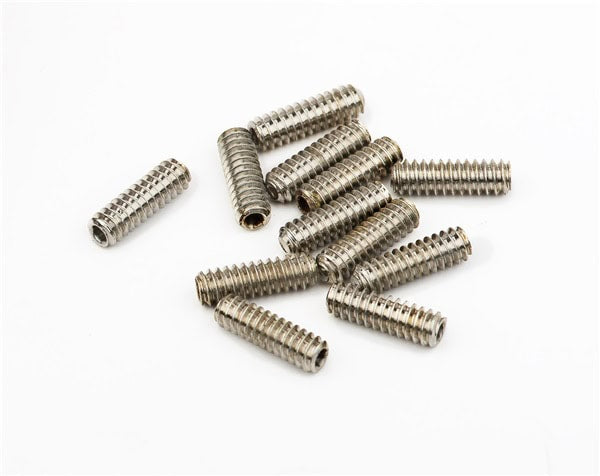 Twelve small metallic screws with threaded bodies arranged on a white surface.