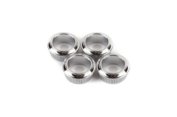 Four silver metal circular bushings for machine tuners on a white background.