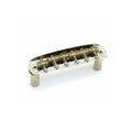 Silver metallic guitar bridge assembly with six adjustable saddles and springs.