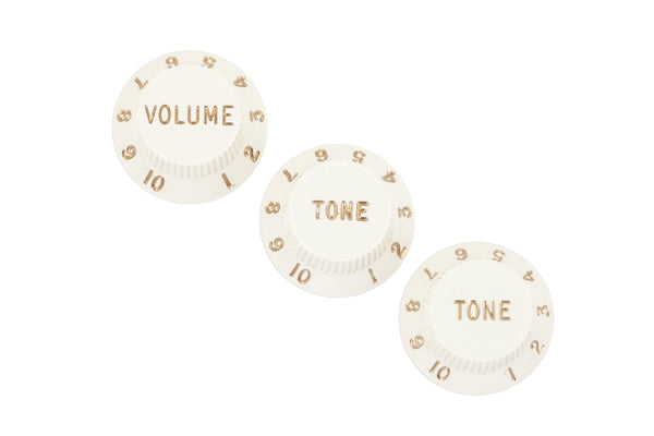Three off-white rotary control knobs labeled Volume and Tone with gold numbering from 1 to 10.