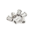 Six small silver metal bushings arranged on a white background.