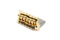 Gold-colored guitar bridge with six adjustable saddles and springs on a white background.