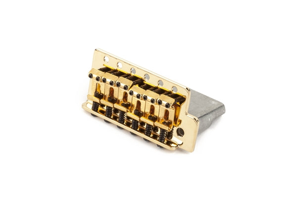 Gold-colored guitar bridge with six adjustable saddles and springs on a white background.