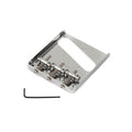 Silver metal guitar bridge plate with three adjustable saddles and a black Allen wrench on a white background.
