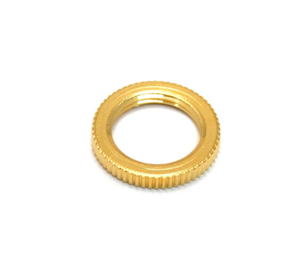 Small gold-colored metal threaded nut with ridged outer edge on a white background.