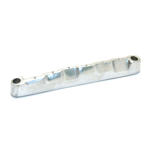 Silver metal guitar bridge saddle with compensated grooves on a white background.