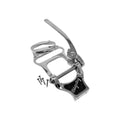 Shiny metal guitar tailpiece and bridge with lever and four screws on white background.