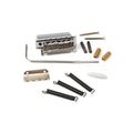 Chrome guitar tremolo bridge assembly with springs, screws, claw, arm, barrel nuts, and white plastic tip.