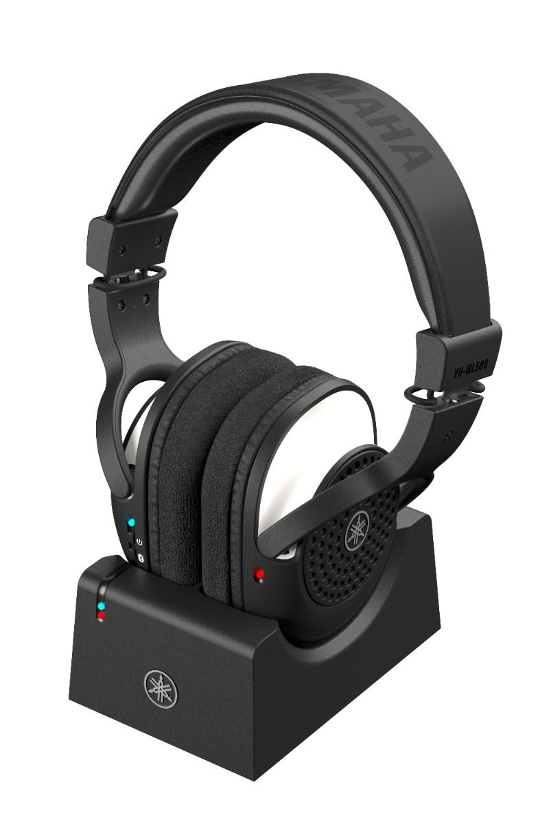 Black Yamaha YH-WL500 wireless headphones resting on a black charging dock with indicator lights.