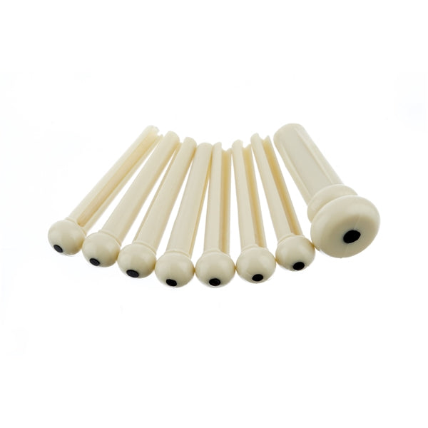 Seven ivory bridge pins with black dots arranged on a white background.