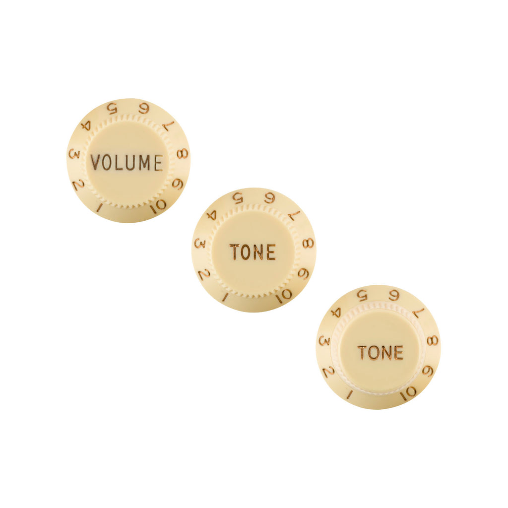 Three aged white rotary knobs labeled VOLUME and TONE with numbers 1 to 10 around edges.