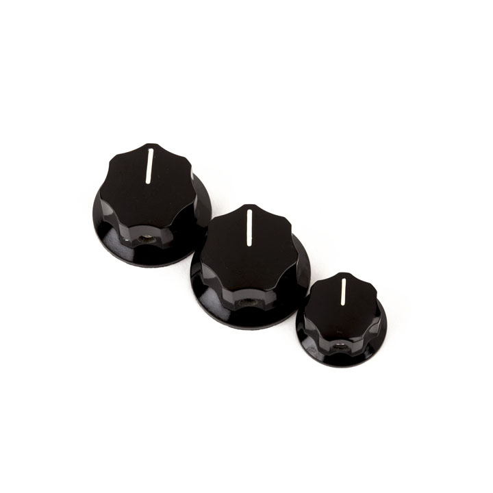 Three black control knobs of different sizes with white indicator lines arranged in a row.
