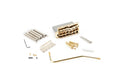 Gold-colored guitar tremolo bridge assembly with springs, screws, tremolo arm, and small parts on white background.