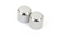 Two chrome dome-shaped metal knobs with knurled sides on a white background.