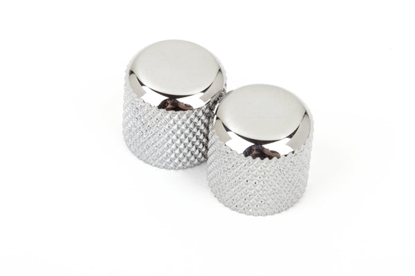 Two chrome dome-shaped metal knobs with knurled sides on a white background.