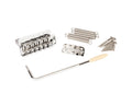 Chrome guitar bridge assembly with tremolo arm, three springs, claw plate, and screws on white background.