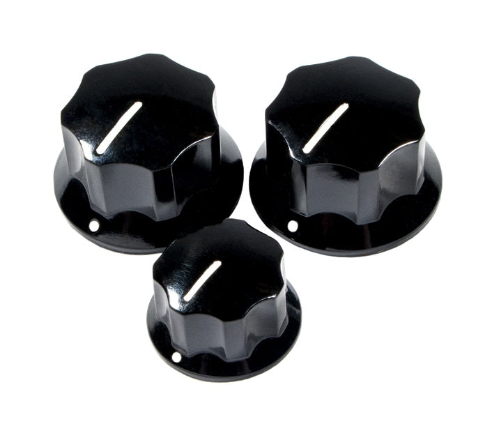 Three black control knobs with white indicator lines for adjusting settings