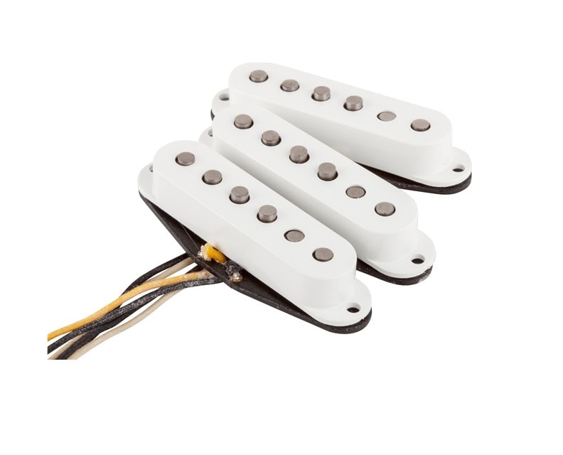 Three white single-coil guitar pickups with attached wire leads on a white background.
