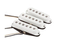 Three white single-coil guitar pickups with exposed wire leads on a white background.