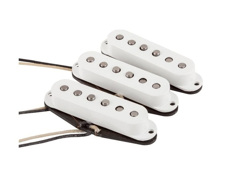 Three white single-coil guitar pickups with exposed wire leads on a white background.
