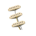 Set of three cream-colored single-coil guitar pickups with attached wires on white background.