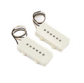 Two white guitar pickups with six visible pole pieces and attached wire leads.