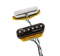 Two guitar pickups with attached wires, one black labeled Fender Noiseless, one silver with Fender logo.