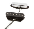 Two electric guitar pickups connected by wires, one with a silver cover and the other with visible pole pieces.