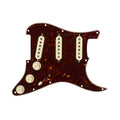 Tortoise shell guitar pickguard with three cream pickups, three control knobs, and a switch.