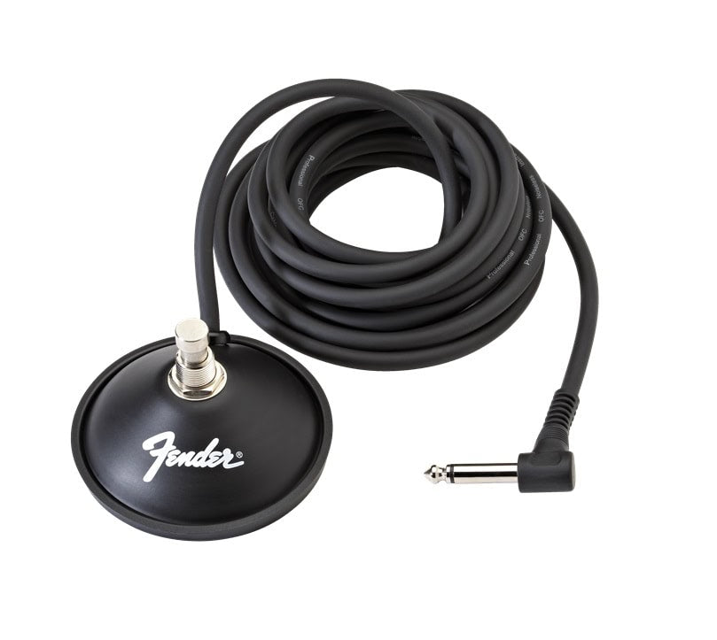 Black round footswitch with a single button and attached coiled cable with right-angle 1/4 inch plug