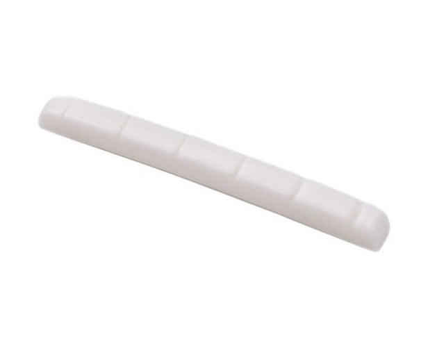 A white pre-slotted string nut with six slots for guitar strings.