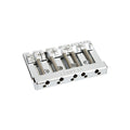 Chrome metal bridge assembly with five string holes and adjustment screws for a bass guitar.