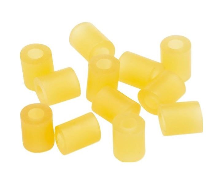 Twelve small yellow rubber tubing pieces arranged loosely on a white background.