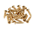 A pile of gold-colored metal screws with Phillips heads on a white background.