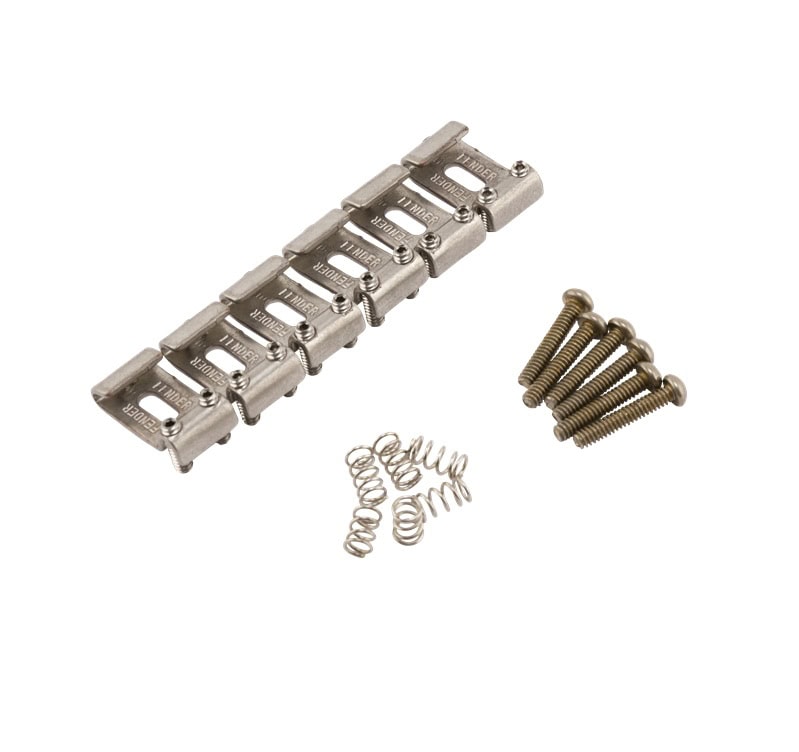 Metal guitar bridge saddles with springs and screws arranged on a white background.