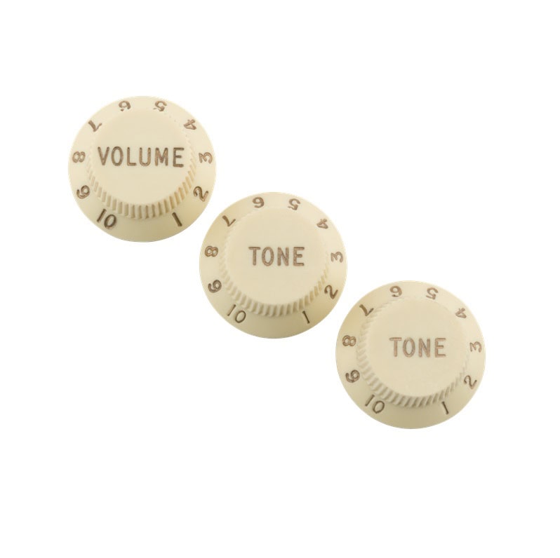 Three off-white rotary control knobs labeled VOLUME and TONE with numbers 1 to 10 around the edges.