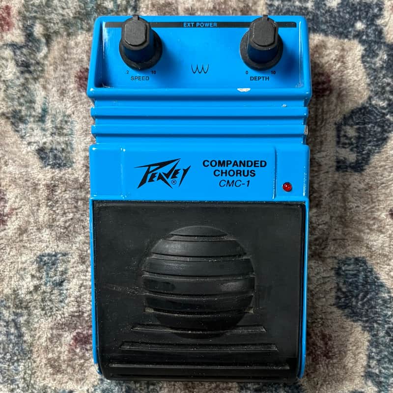 Blue Peavey Companded Chorus CMC-1 guitar effect pedal with two control knobs and a footswitch.
