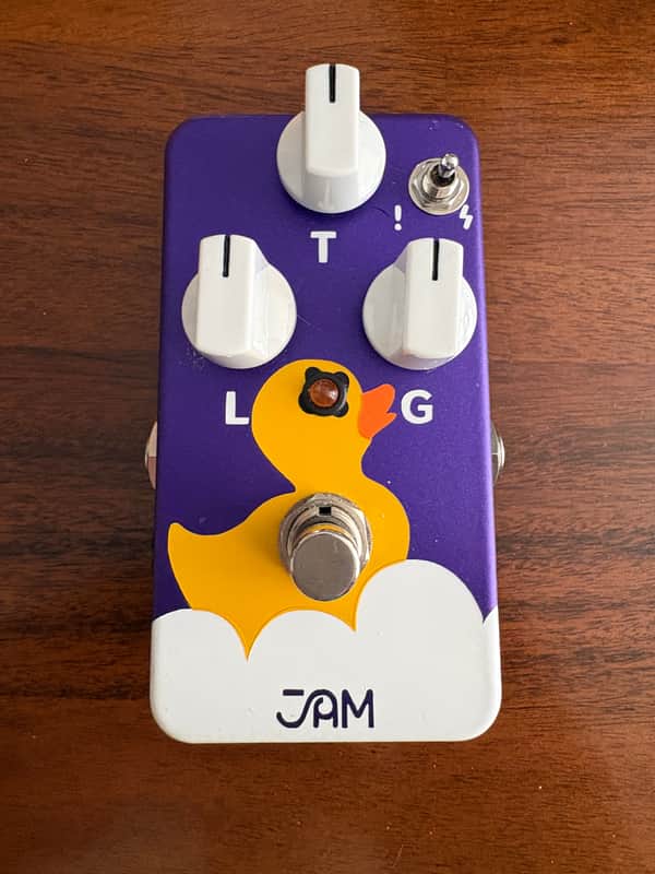 A JAM Pedals Eureka! fuzz guitar pedal in a hand-painted enclosure showing artwork of a rubber duck sitting in a bathtub, with three control knobs, a small three-way toggle switch, a footswitch, and the JAM logo at the bottom.