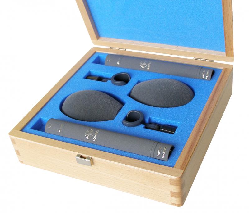 Two black cylindrical microphones with accessories in a blue foam-lined wooden storage case.