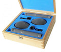 Two black microphones with foam windshields and clips in a blue foam-lined wooden case.