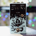 Front view of a light blue guitar effects pedal with knobs, toggle switch, footswitch, and graphic art on the faceplate.