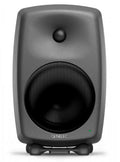 Front view of a black Genelec studio monitor speaker with two drivers and a green indicator light.